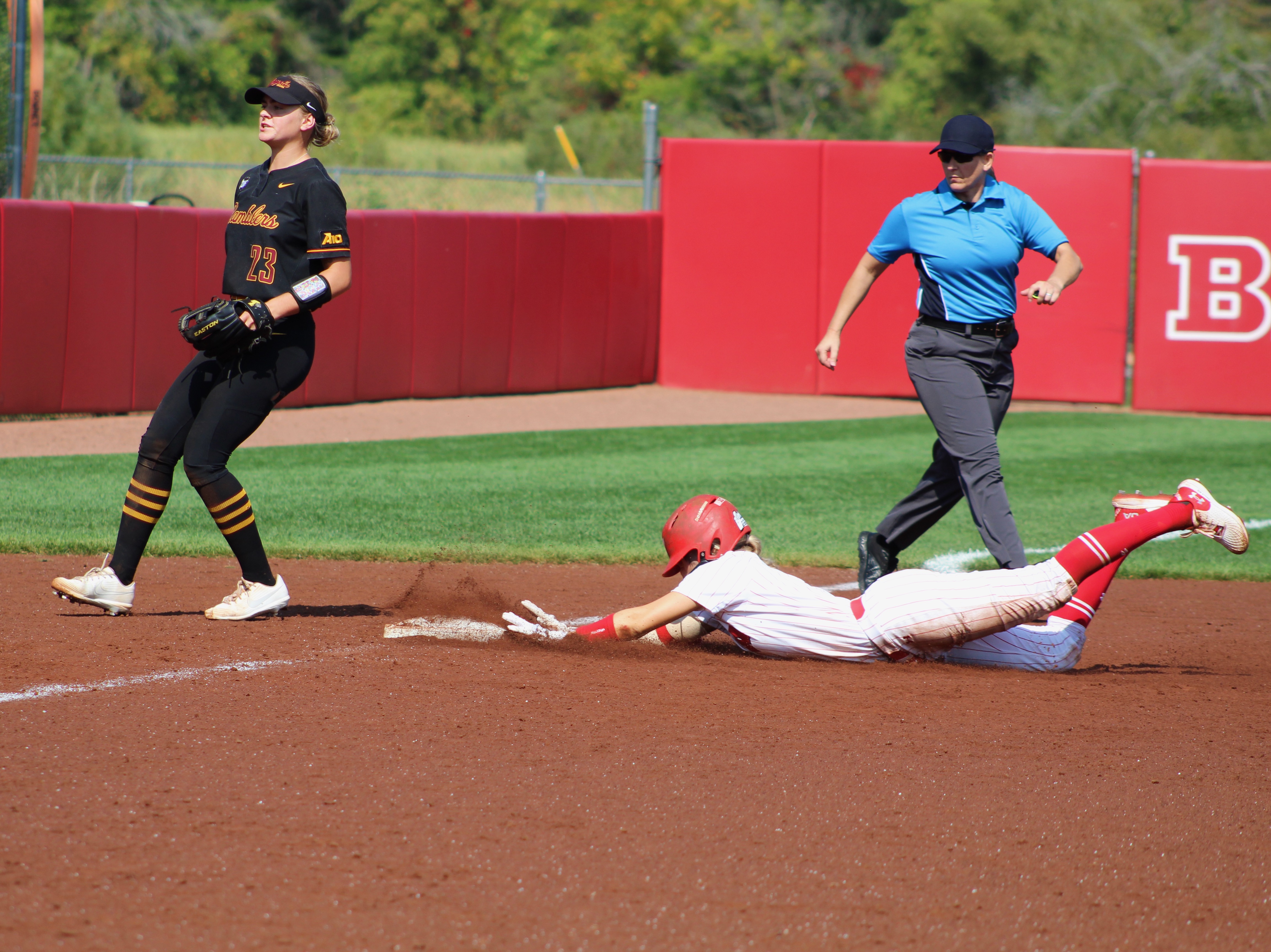 Wisconsin player slides to third base against Loyola Chicago
